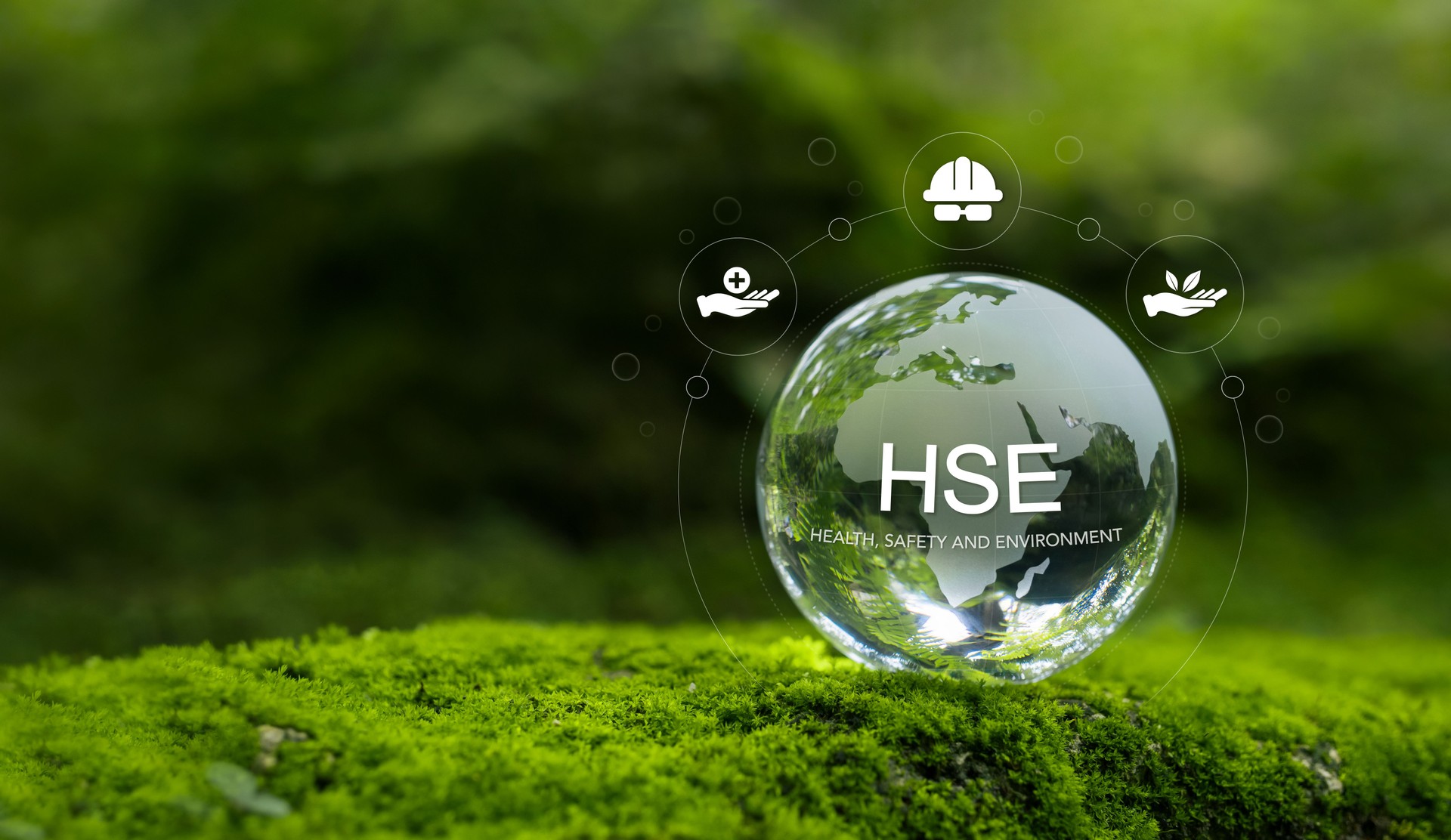 Health, Safety and Environment HSE concept focusing on accident prevention, environmental protection, health and safety for business and organization. Crystal ball on moss in forest, green background.